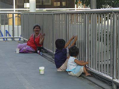 Beggars on pedestrian bridge over Sukhumvit Road, Bangkok, Thailand Beggars on a Pedestrian Bridge in Bangkok